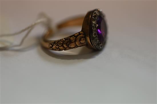 A George III gold, foil backed amethyst and diamond set oval ring, size L.